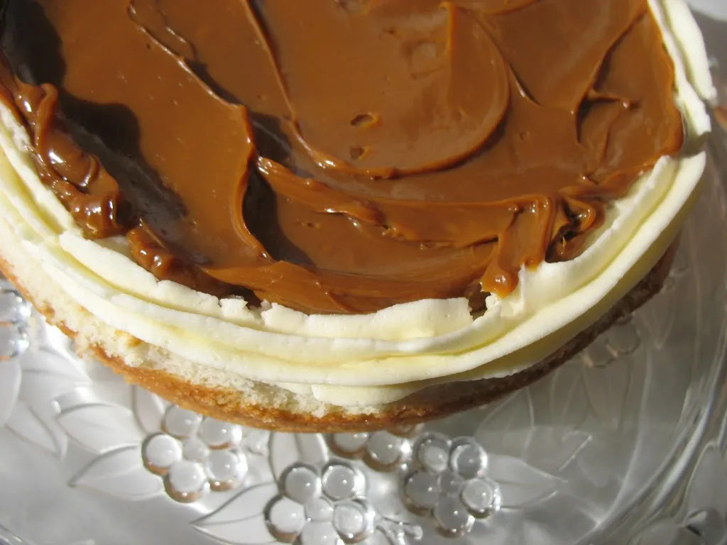 cake layer with outer icing piping with a caramel filling