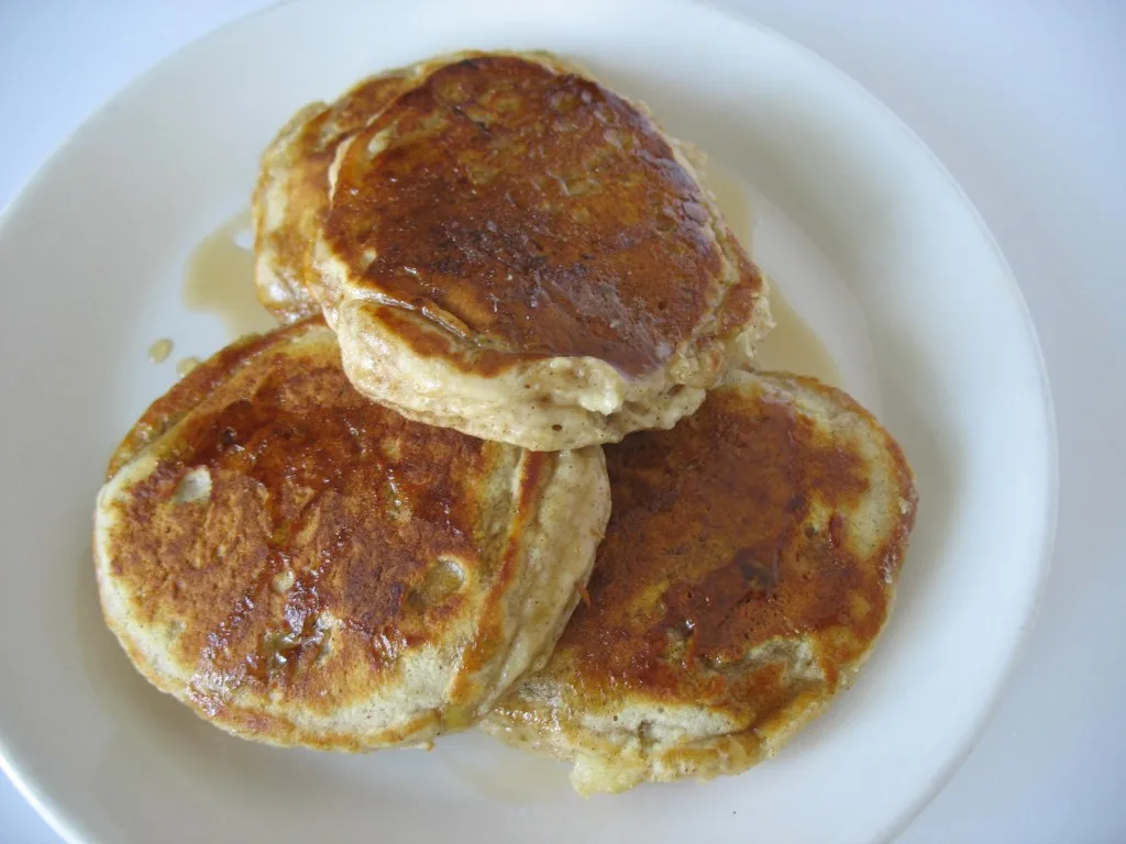 banana bread pancakes on white plate with syrup