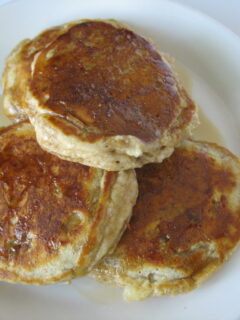 banana bread pancakes on white plate with syrup