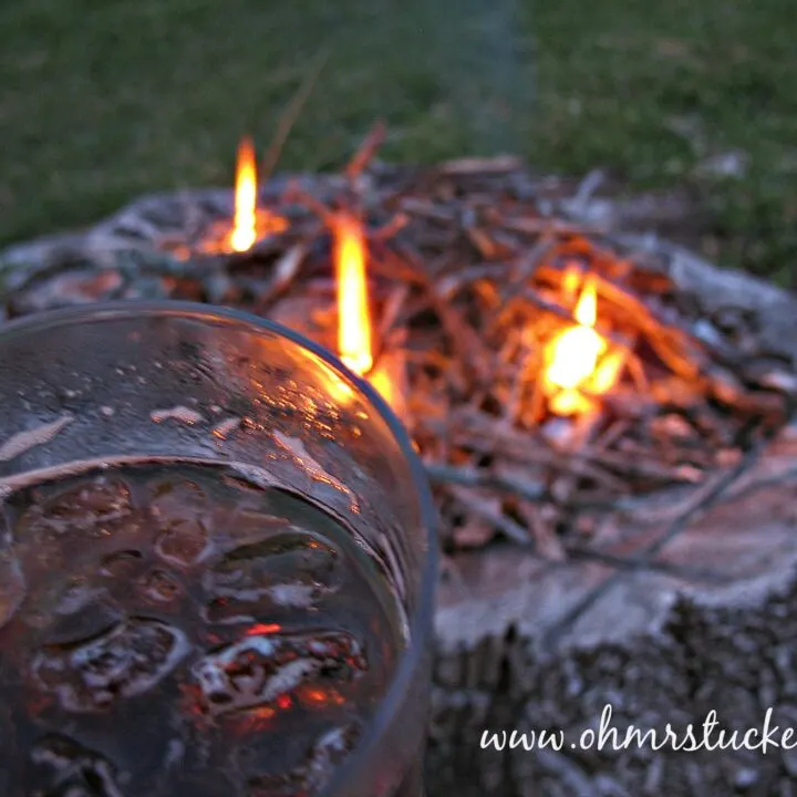 fire in a stump with glass of liquid