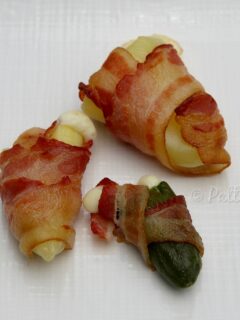Jalapeno and Fresno Chili Poppers on white background wrapped in bacon