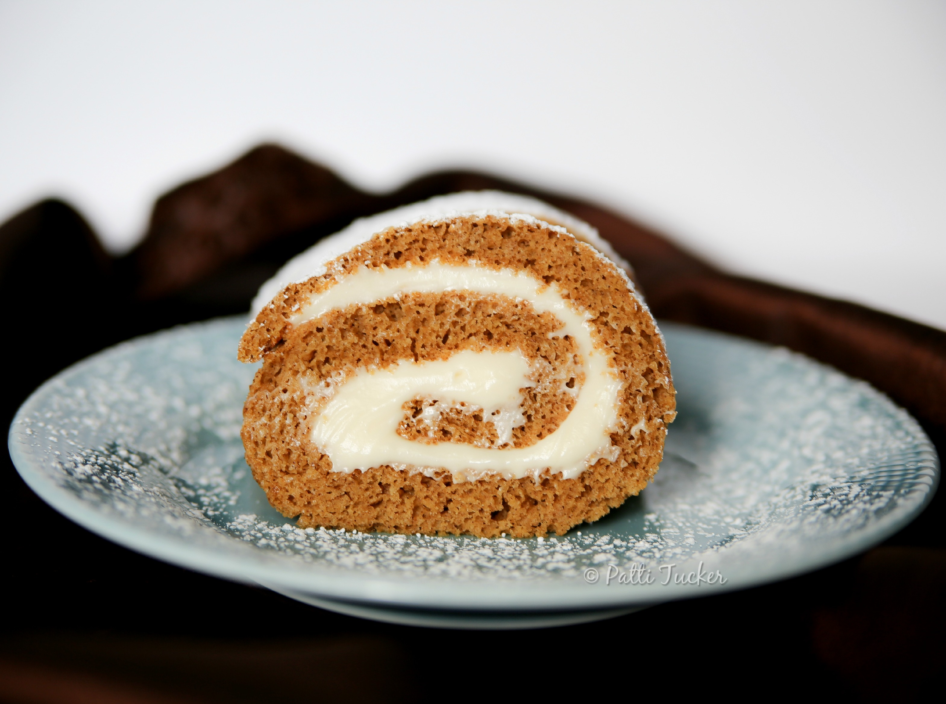 slice of pumpkin roll on blue plate