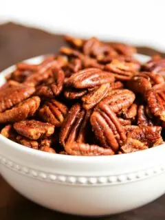 Savory Roasted Pecans in a white bowl on a table