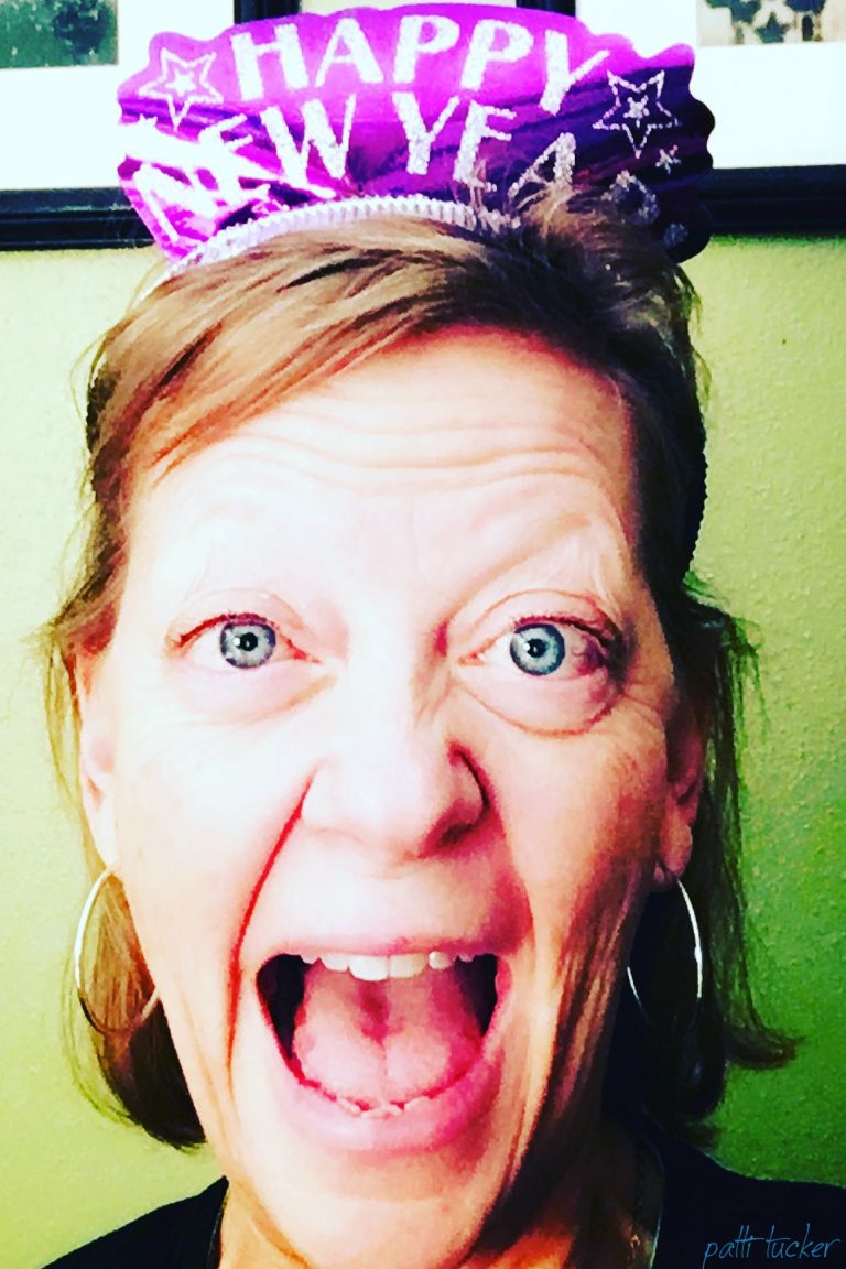 joyful woman's face wearing a happy new year hat