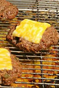 three cheeseburgers on a rack