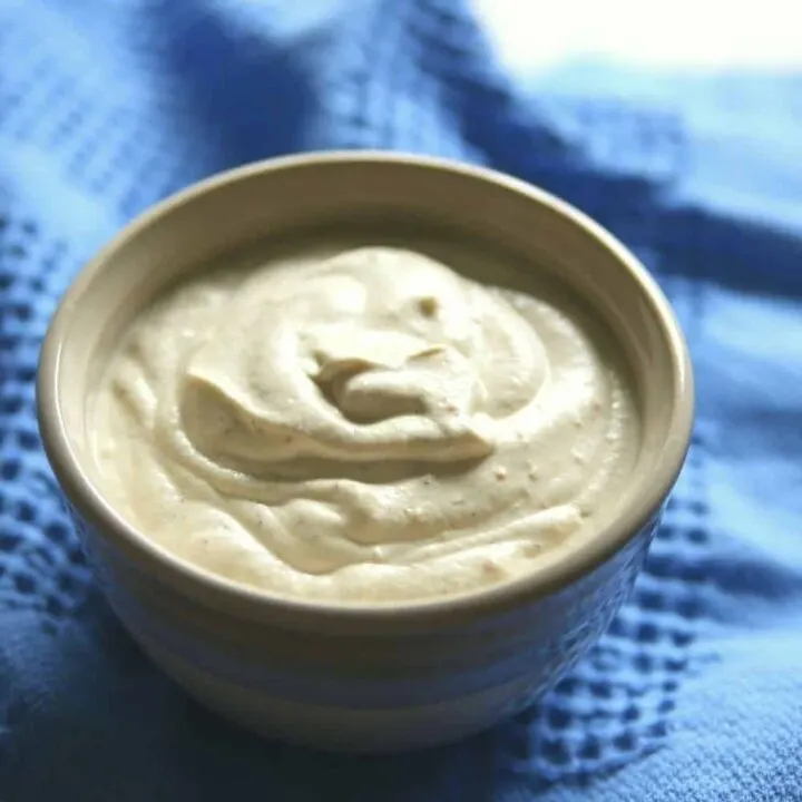 plant-based sour cream in bowl on blue cloth