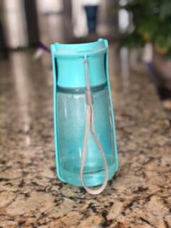 Aqua colored Portable dog water bottle on counter