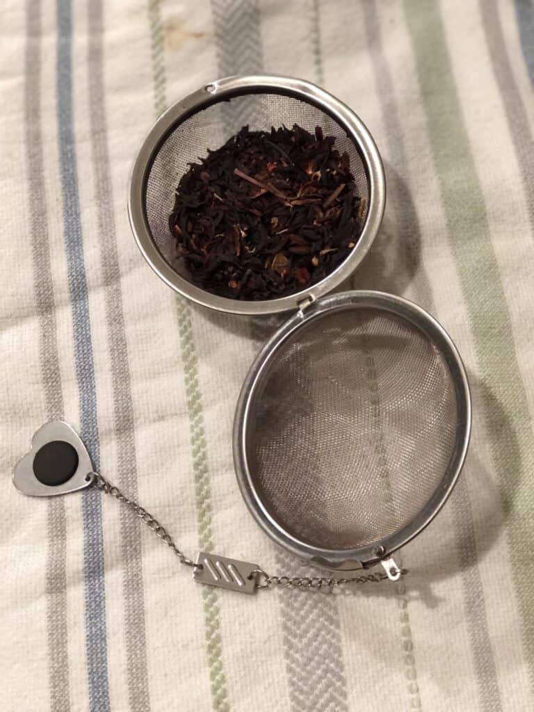 open tea ball with tea in one half