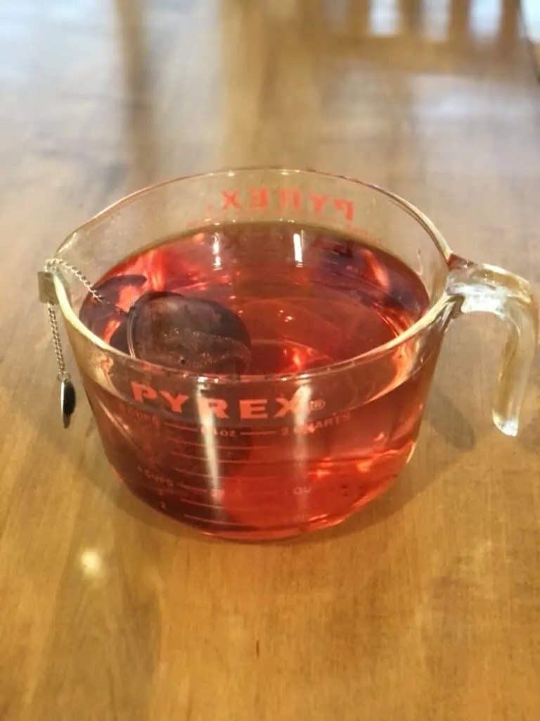 pyrex measuring cup with teaball and hibiscus tea